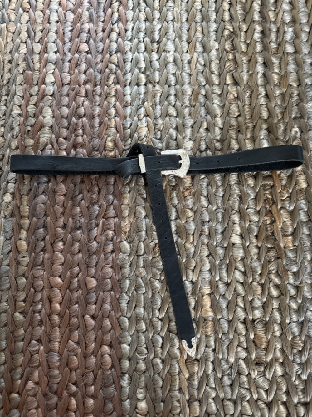 Black elongated Western style leather belt with engraved silver buckle